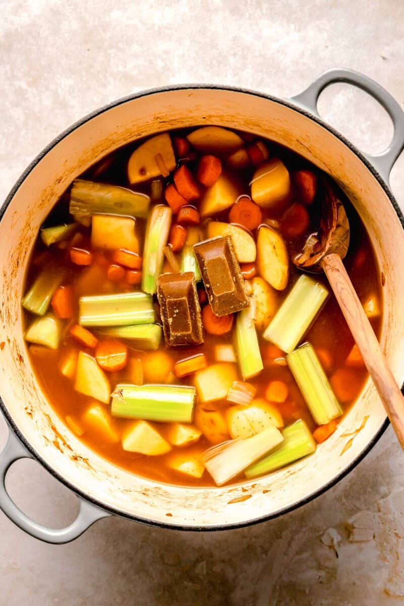 Adding curry cubes to katsu chicken curry.