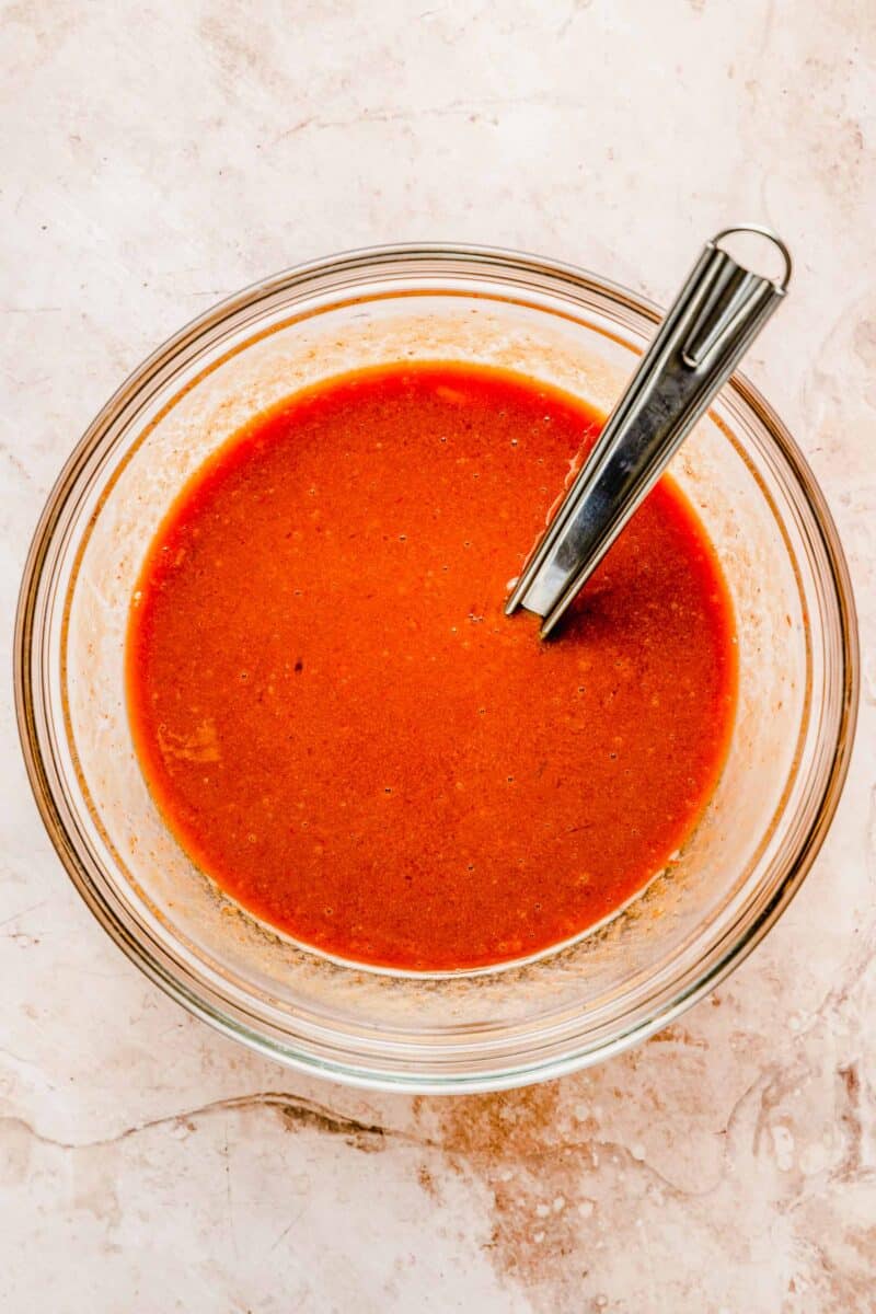 Sauce for classic meatloaf in a bowl with a spoon.