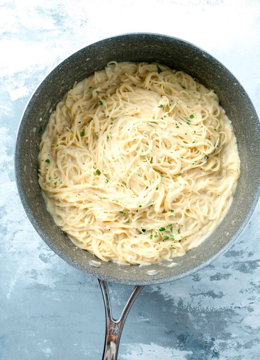 cooked garlic parmesan pasta in a nonstick skillet