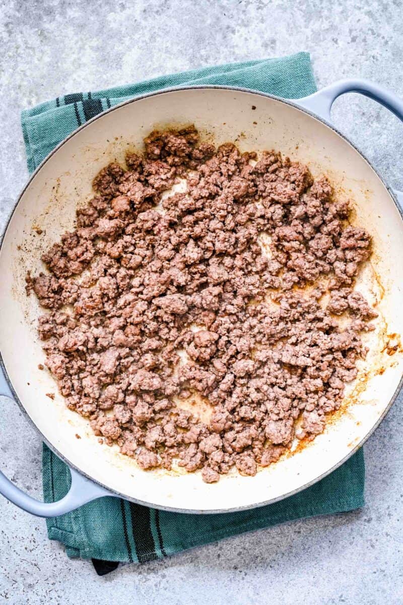 browning ground beef in a cast iron skillet