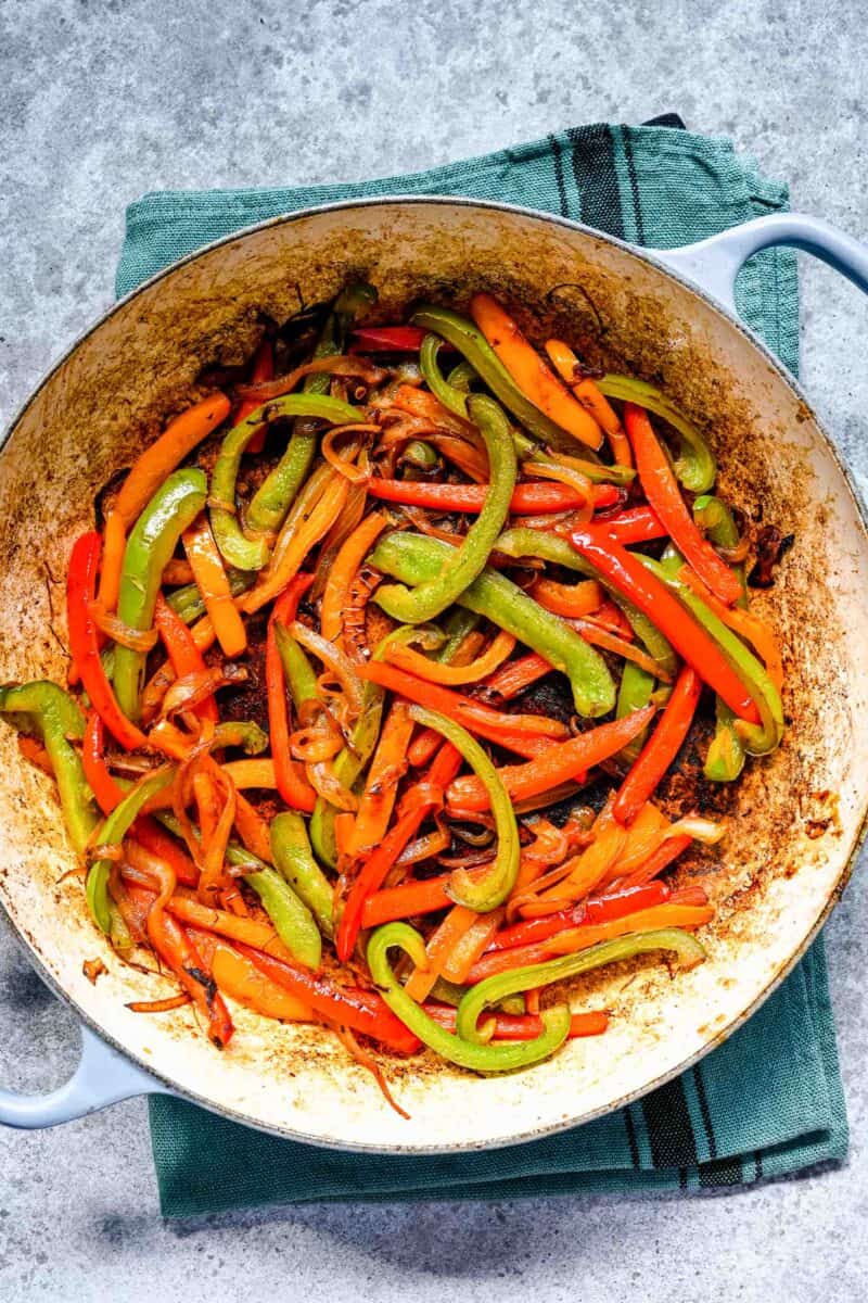 cooked down fajita vegetables in cast iron skillet