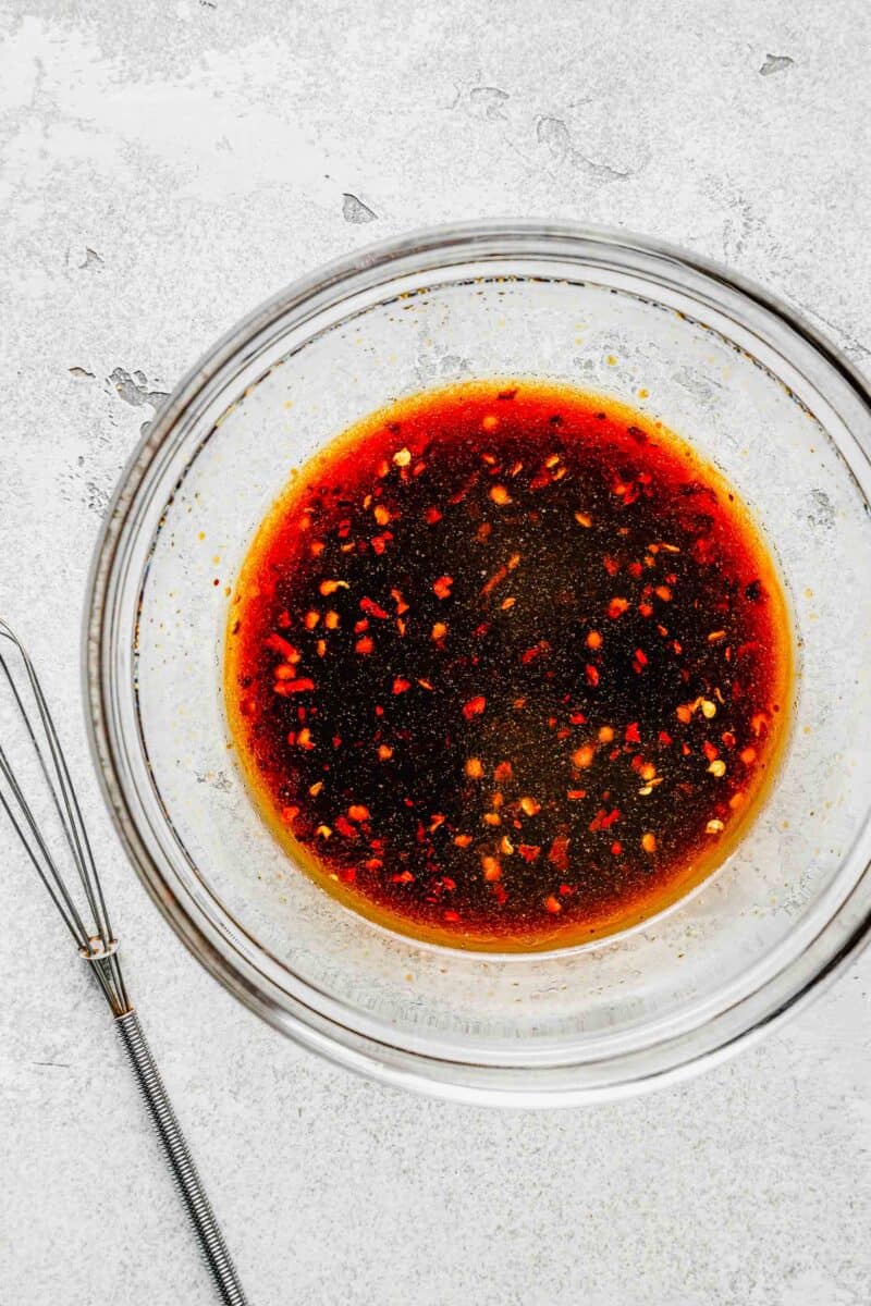 Sauce for Korean beef bulgogi in a bowl near a whisk.