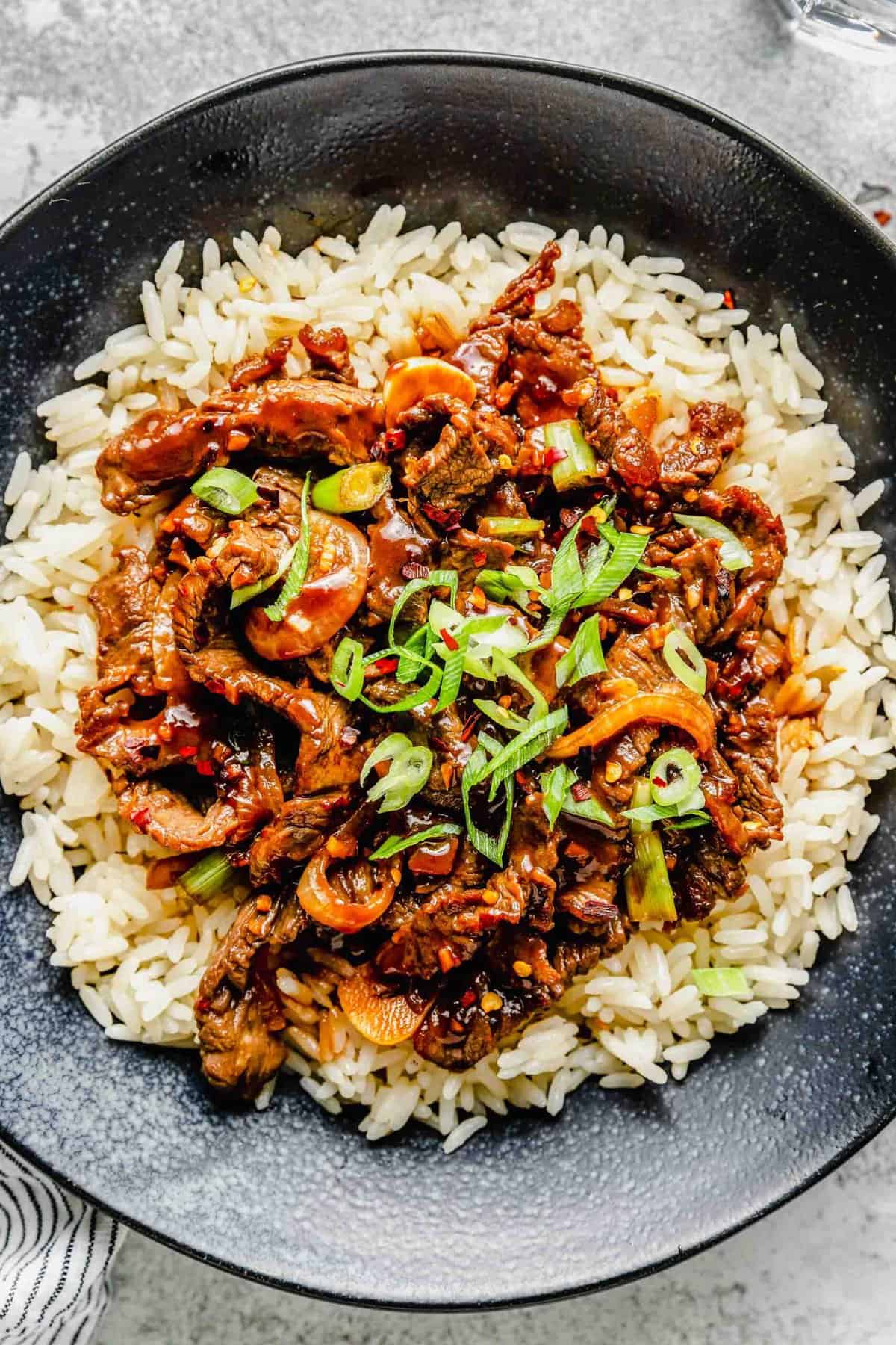 Korean beef bulgogi served over rice in a bowl.