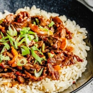 Korean beef bulgogi served over rice in a bowl.