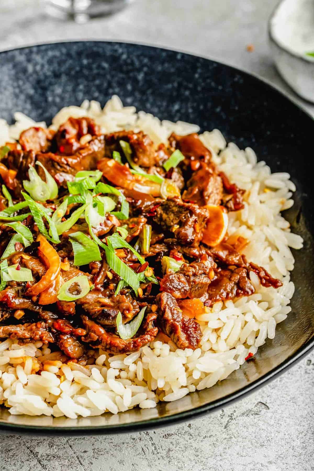 Korean beef bulgogi served over rice in a bowl.