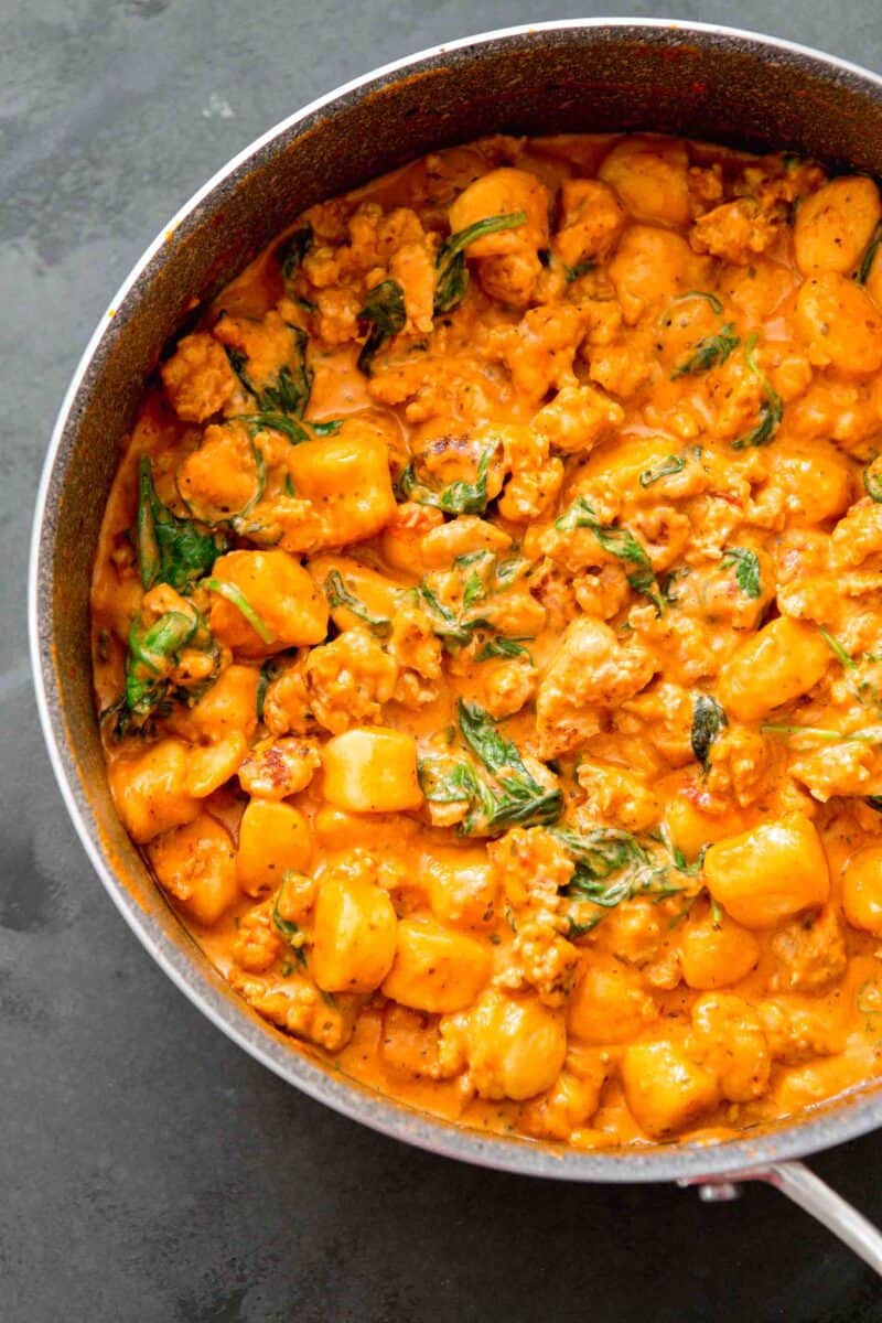 overhead image of one pan creamy chicken and gnocchi in the skillet