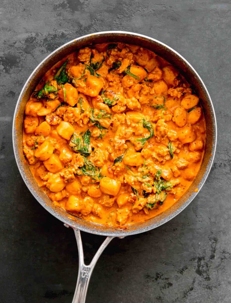 one pan creamy chicken and gnocchi in the skillet all tossed together in the creamy sauce