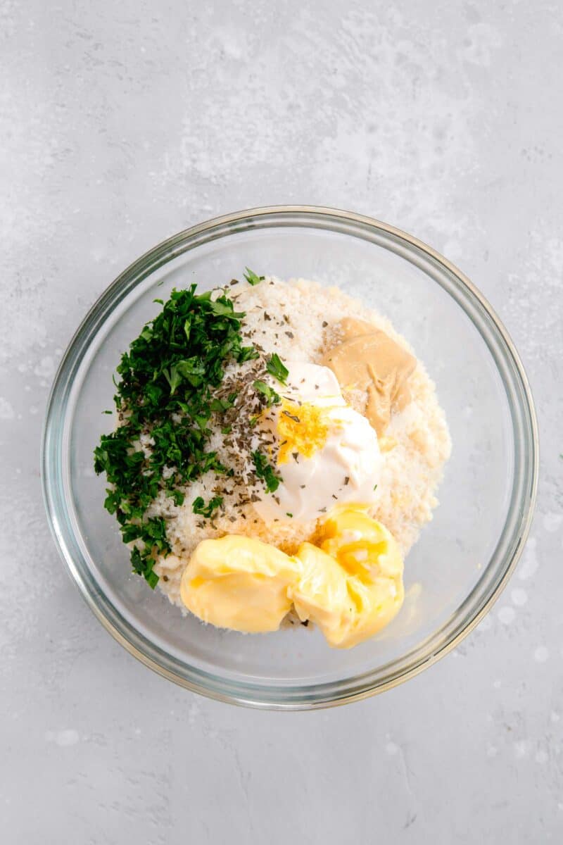 panko parmesan mixture in a clear bowl (panko, parmesan, parsley, dried basil, lemon zest, butter, mayo, dijon mustard)