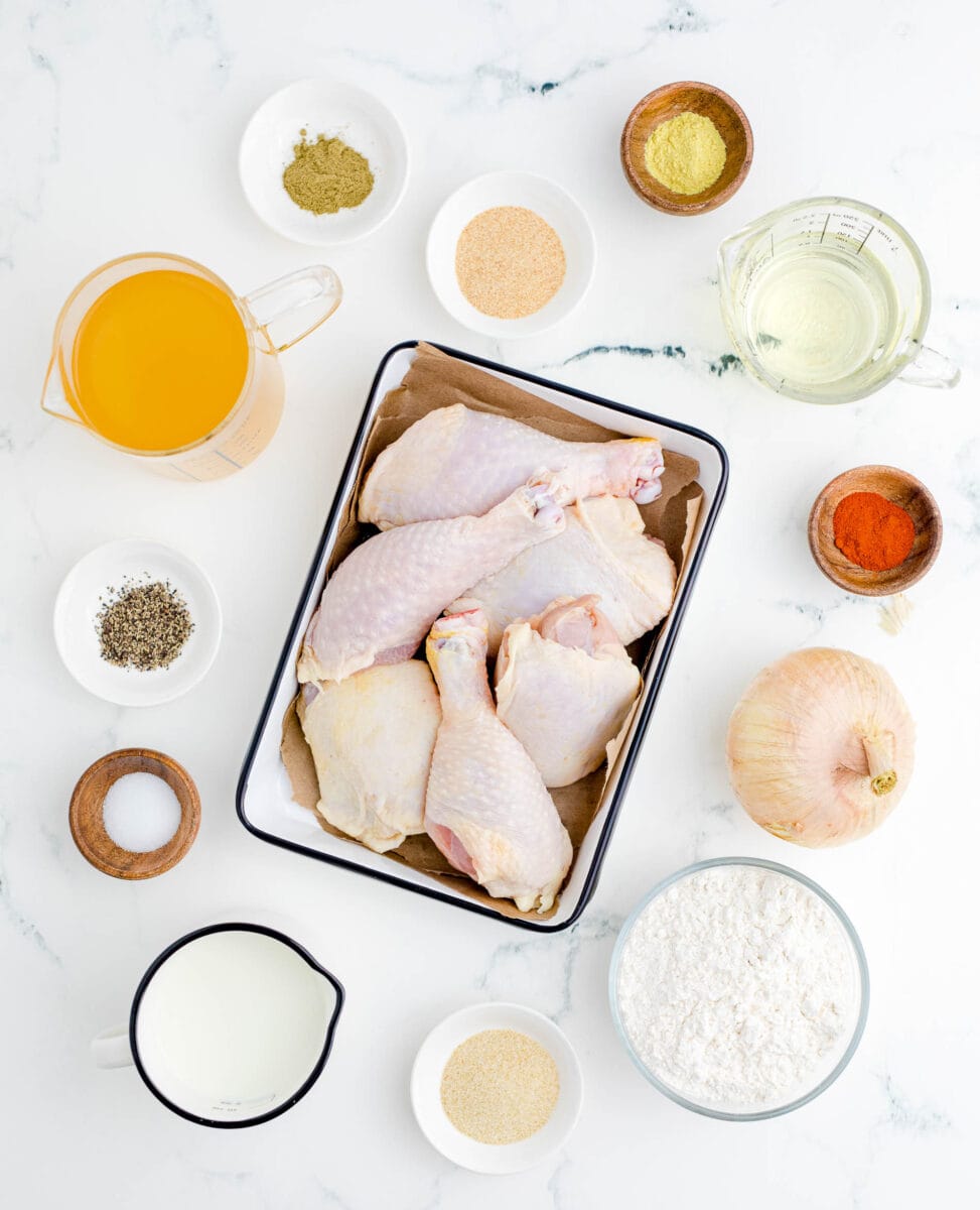 ingredients for smothered chicken: bone-in, skin-on chicken thighs and legs, paprika, onion, flour, garlic powder, milk, salt, pepper, chicken broth, poultry seasoning, onion powder, chicken bouillon, and vegetable oil