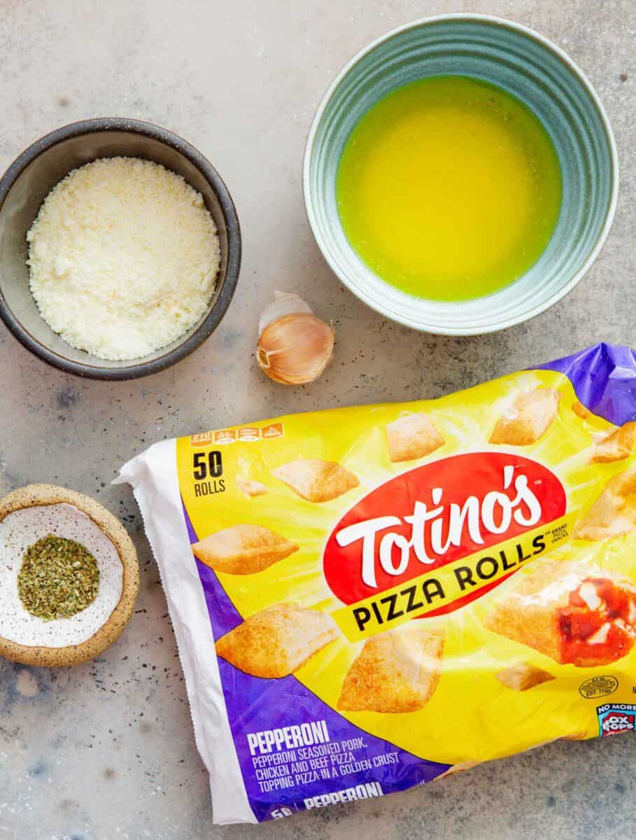 ingredients for pizza rolls: melted butter, grated parmesan cheese, garlic, italian seasoning, and frozen pizza rolls