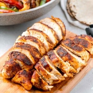 sliced air fryer blackened chicken on a wooden cutting board