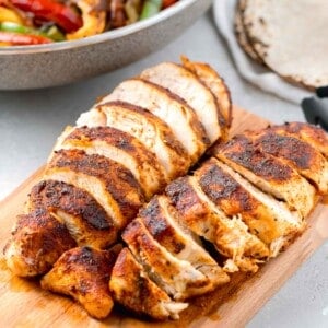 sliced air fryer blackened chicken on a wooden cutting board