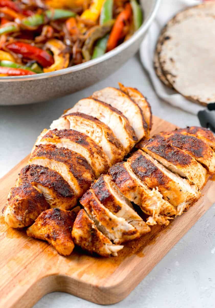 sliced air fryer blackened chicken on a wooden cutting board