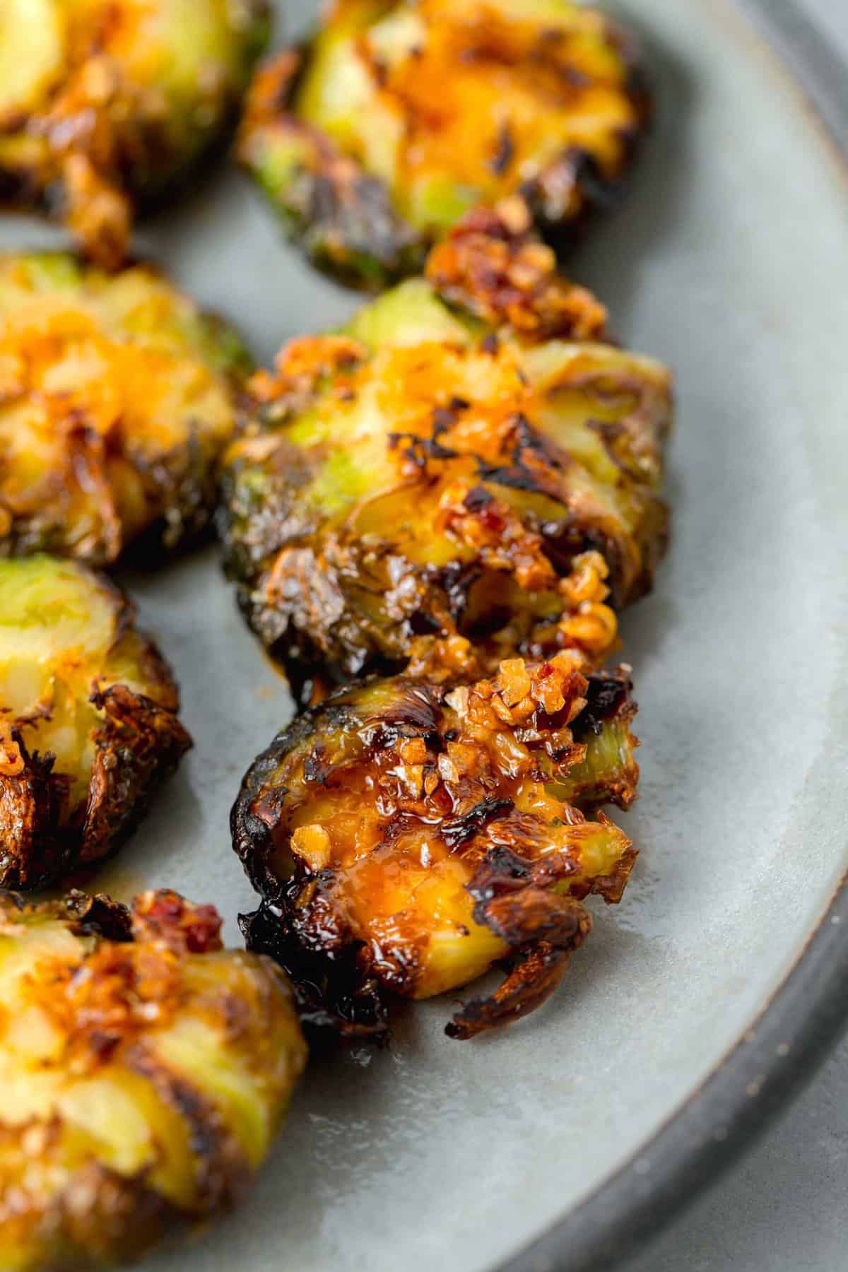 garlic chili crisp oil on top of crispy smashed brussels sprouts
