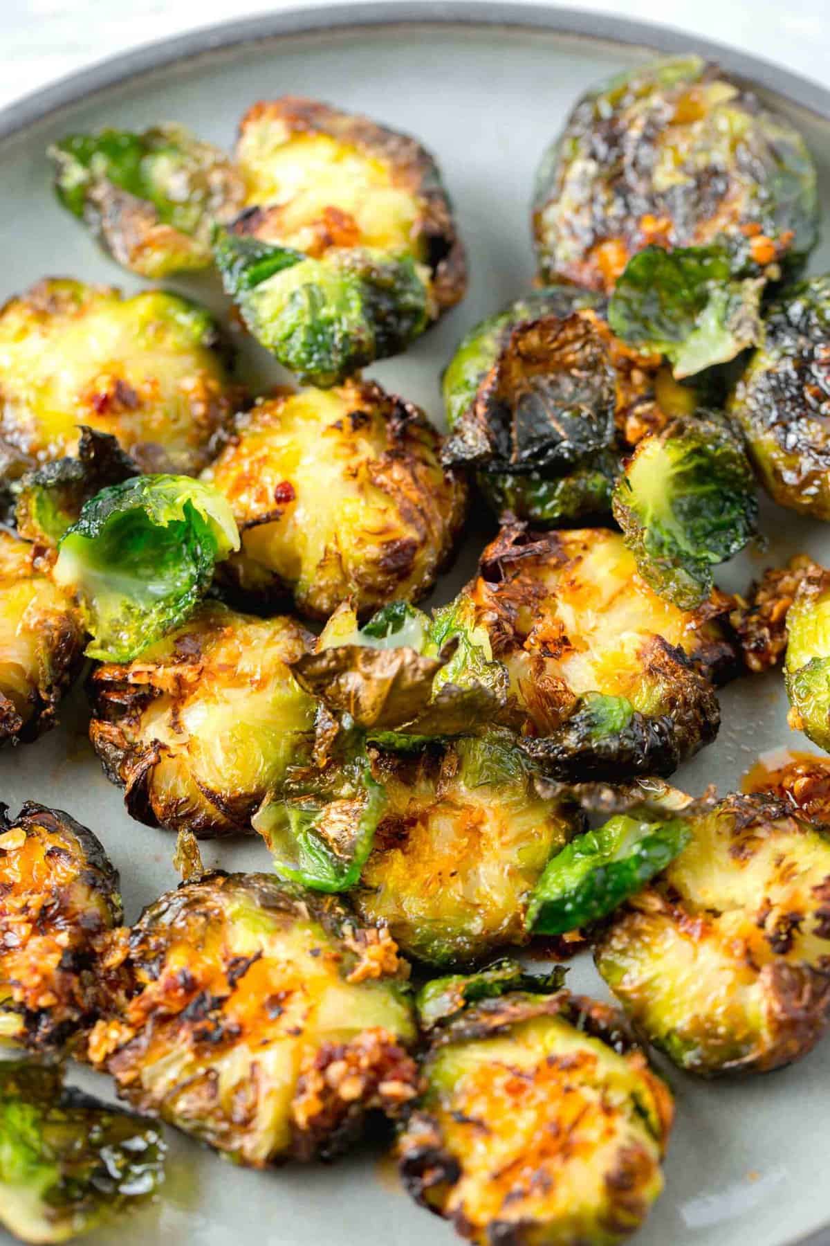 garlic chili crisp oil on top of crispy smashed brussels sprouts