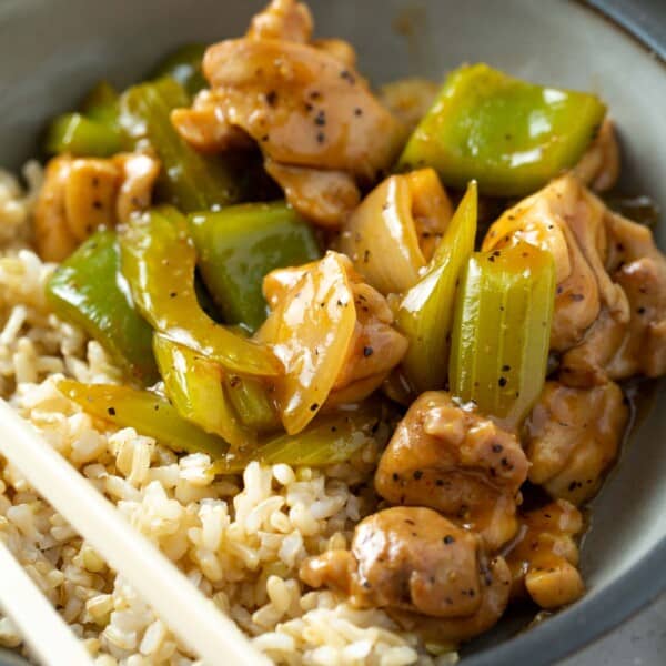 black pepper chicken in a bowl with brown rice