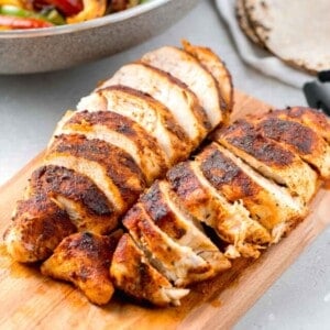 sliced air fryer blackened chicken on a wooden cutting board