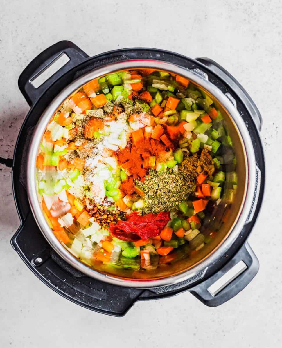 seasonings are spread across the top of cooked vegetables in an instant pot.