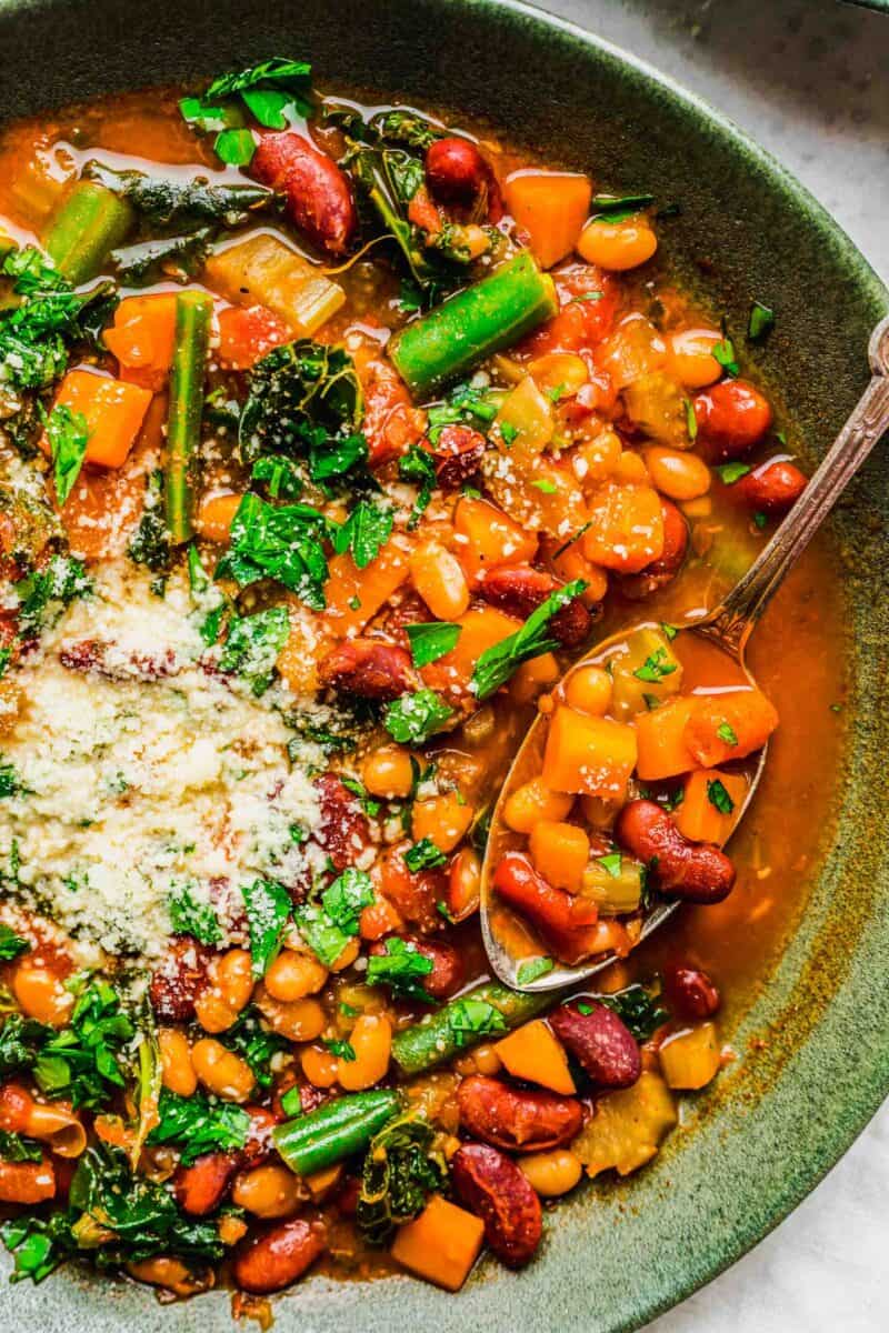 a close up image shows the vibrant colors of the beans and vegetables in the soup.