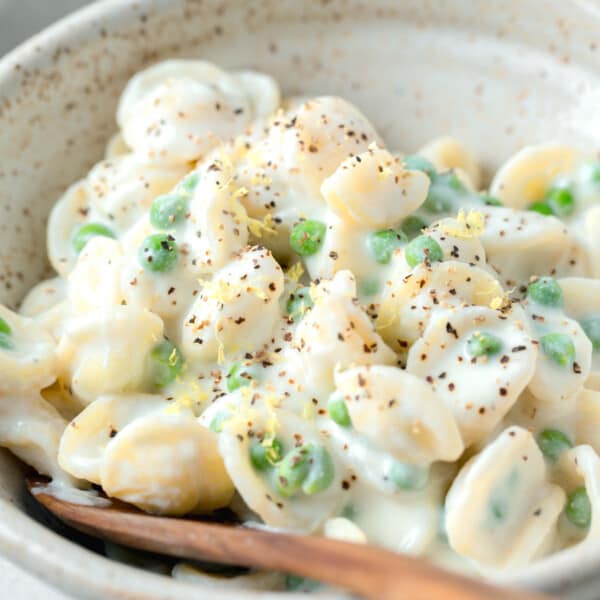 ricotta and lemon pasta in a bowl with lemon zest and cracked black pepper on top