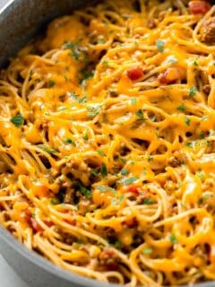taco spaghetti with melted cheese in a skillet