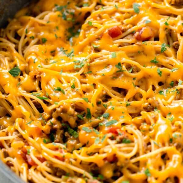 taco spaghetti with melted cheese in a skillet