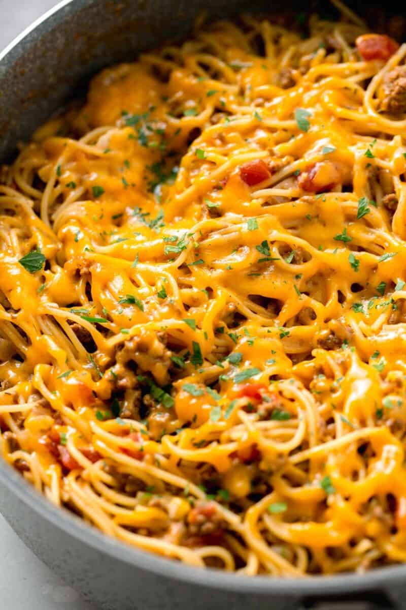 taco spaghetti with melted cheese in a skillet