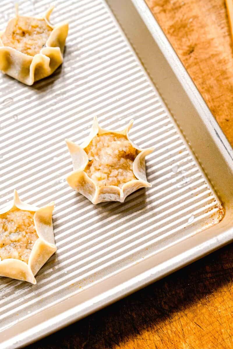 Shrimp shumai on a sheet pan ready to be steamed.