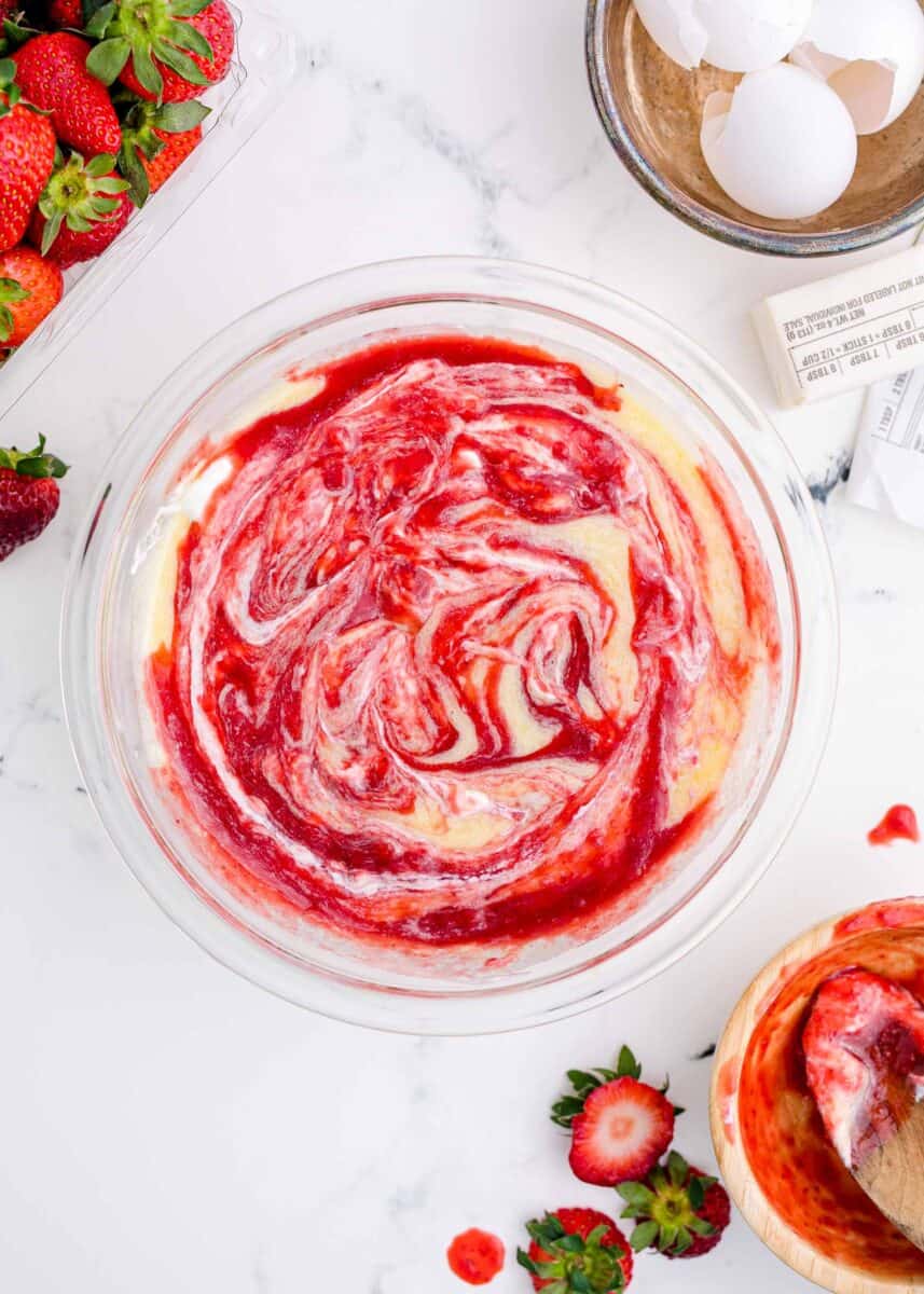 strawberry sheet cake batter with sour cream and strawberry reduction swirled in
