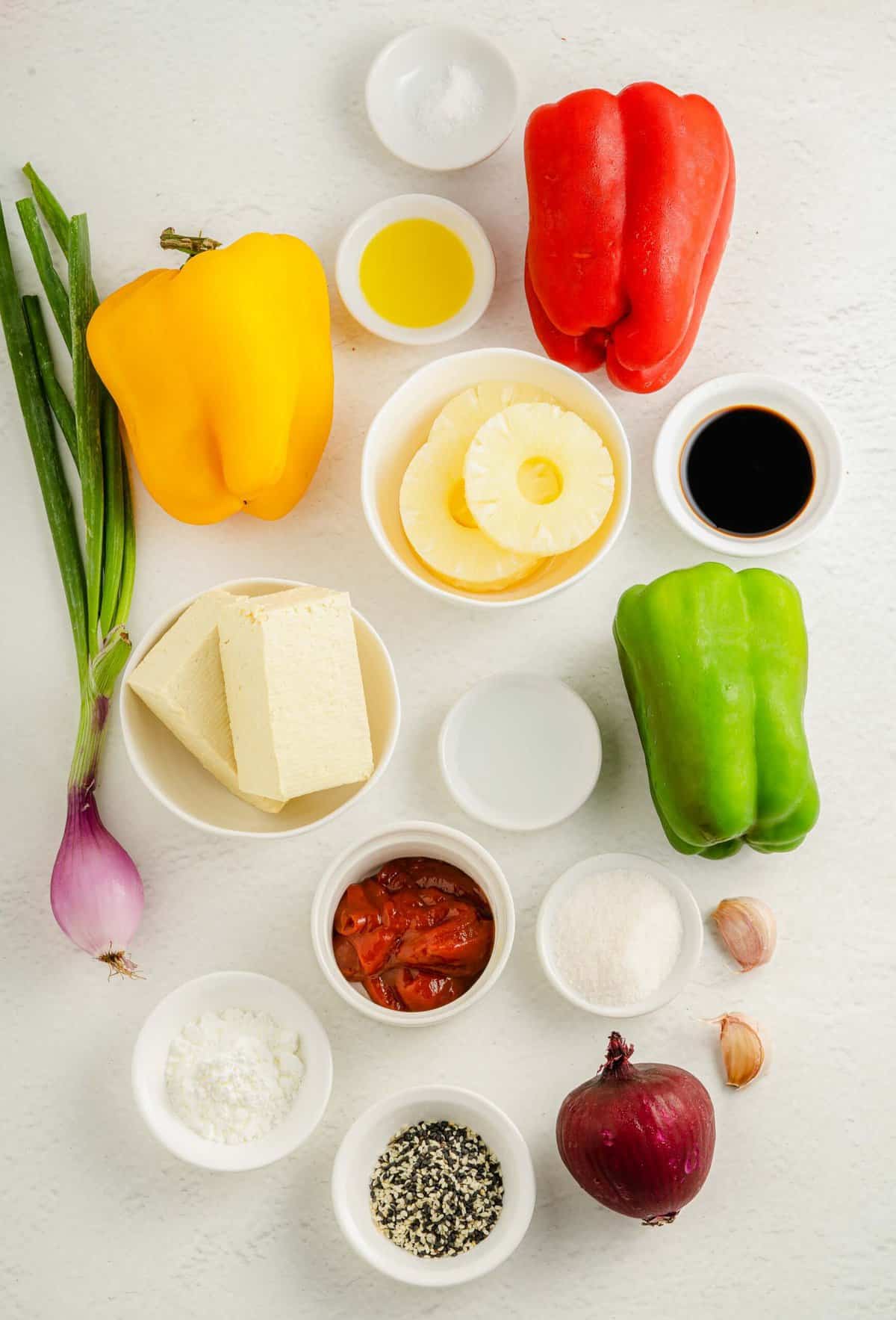 The ingredients for sweet and sour tofu are placed on a white surface.