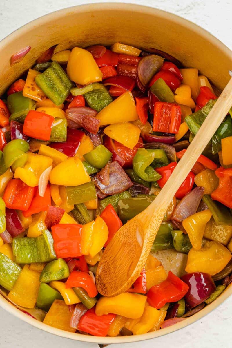 veggies are being cooked in a pot.