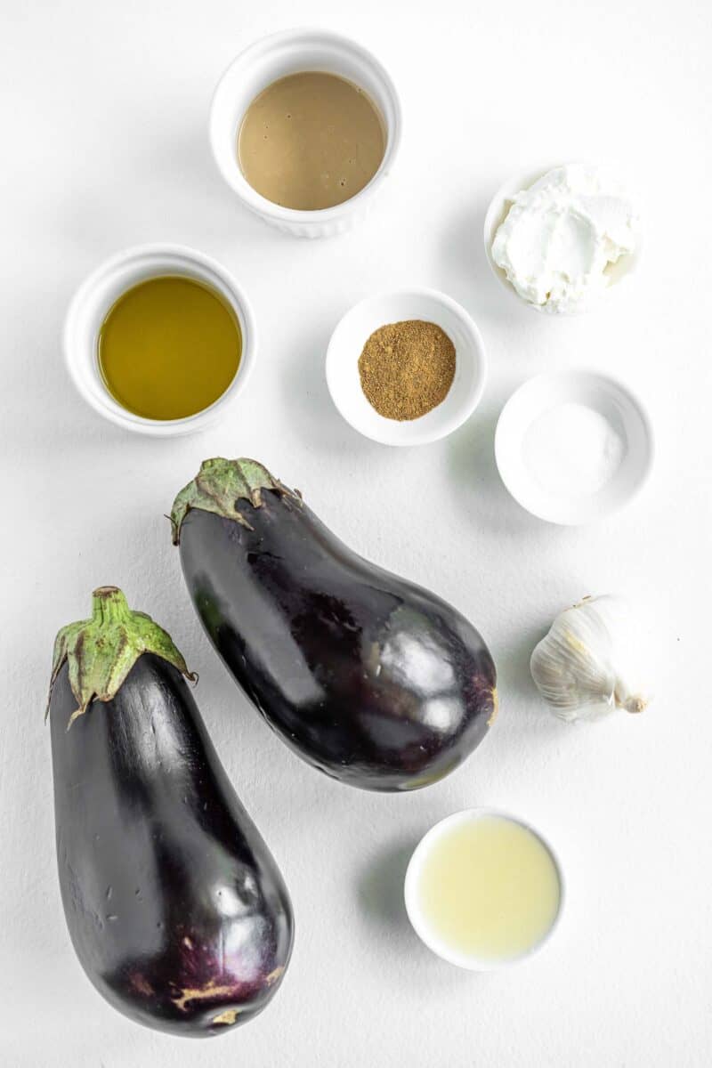 the ingredients for Baba Ganoush are placed on a white surface.