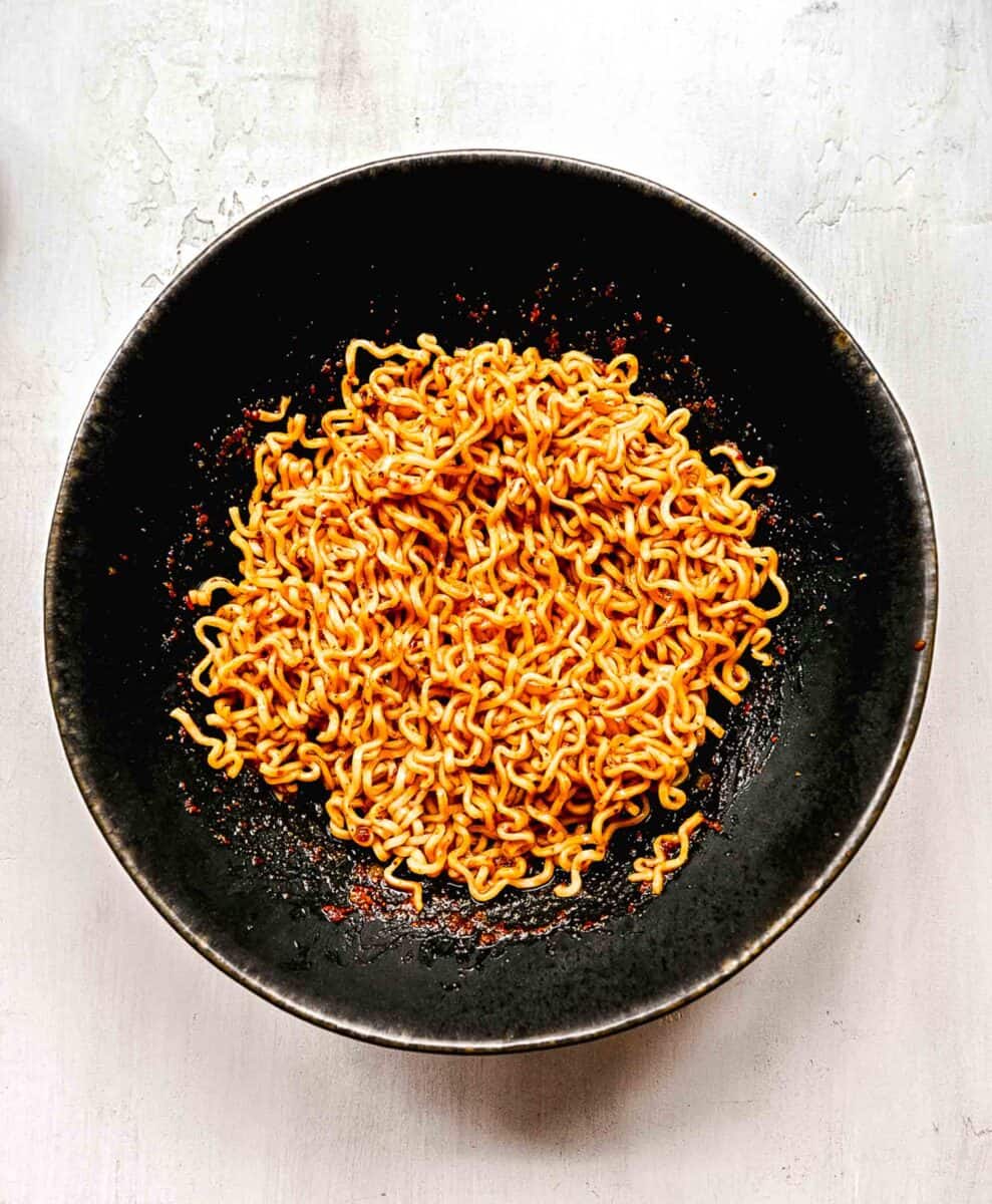Ramen noodles coated in sauce.