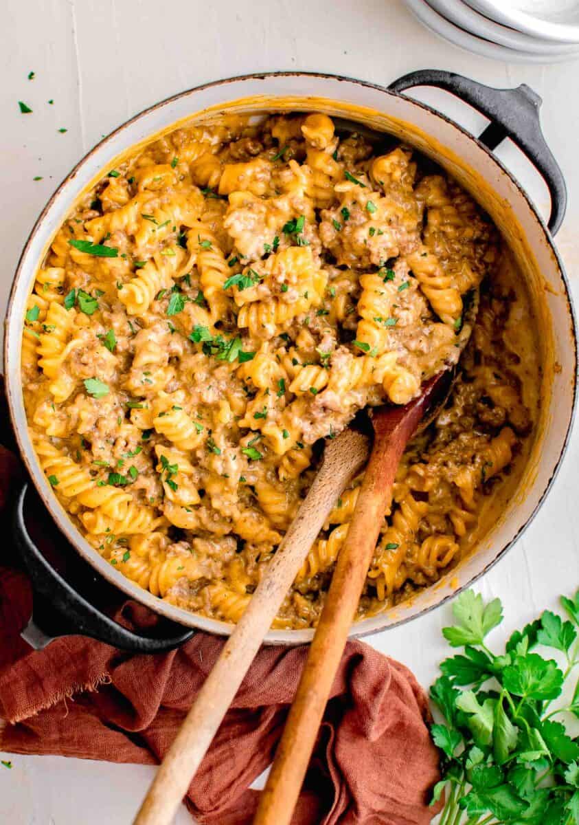 a large pot is filled with cooked cheeseburger pasta.