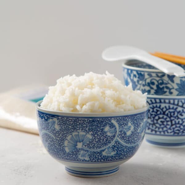 instant pot jasmine rice in a decorative blue bowl with other blue bowls in the background