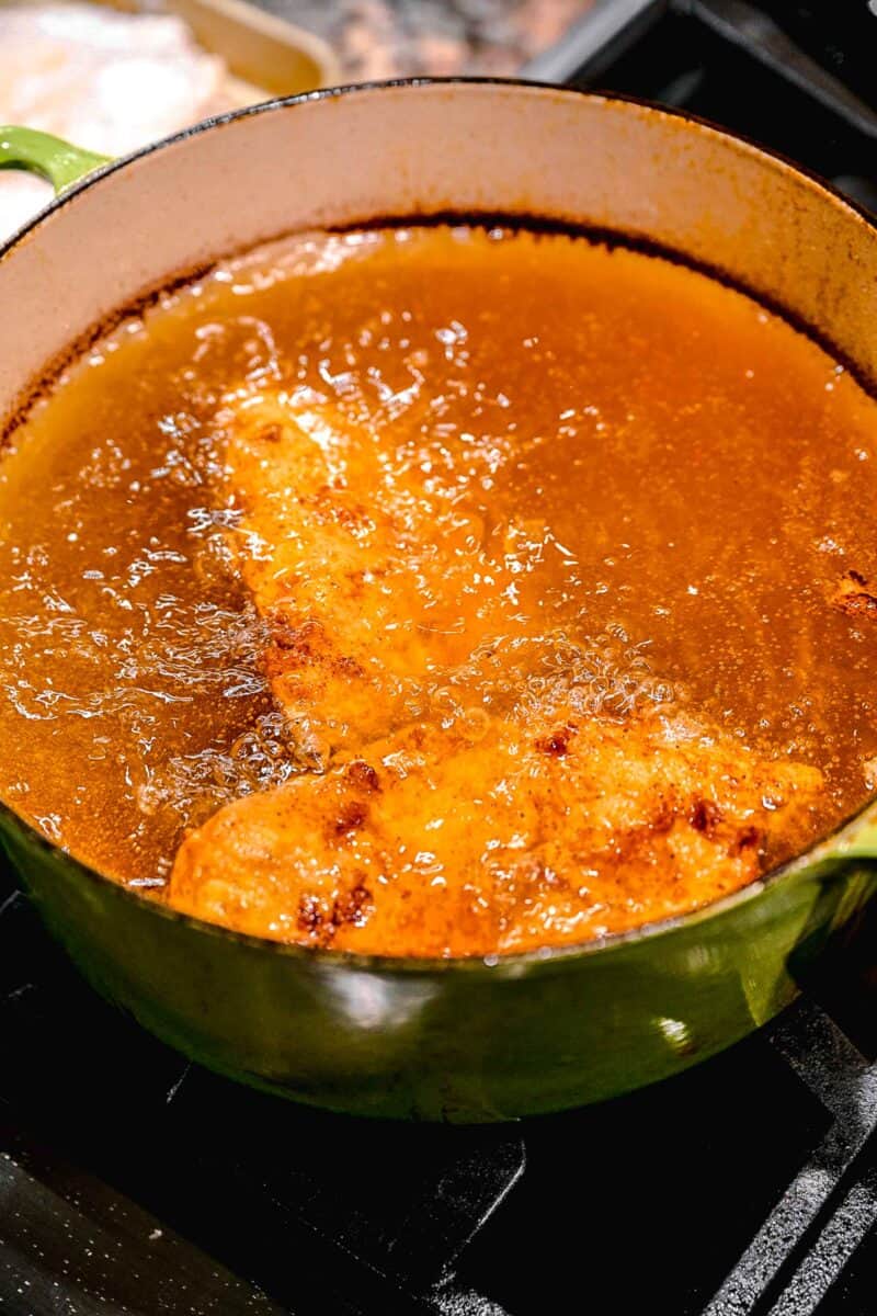 Frying chicken in oil.