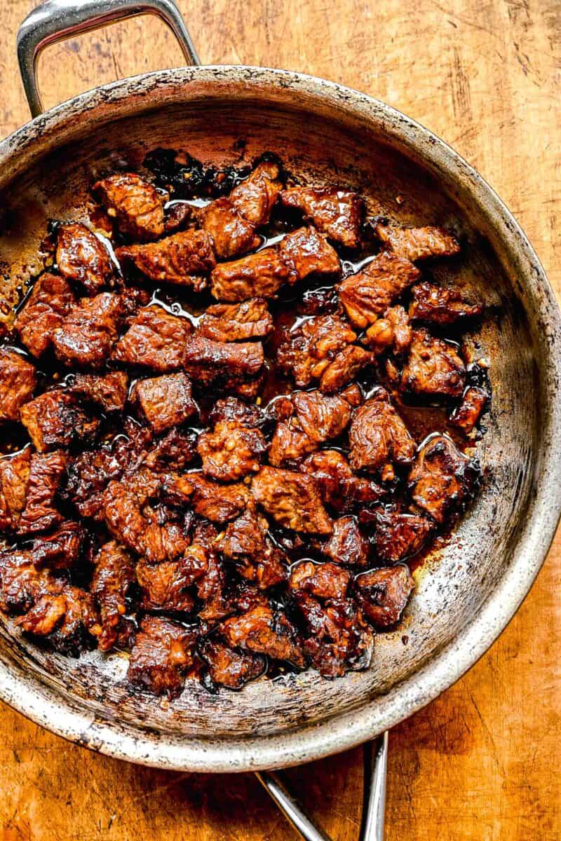 Searing shaking beef in a pan.