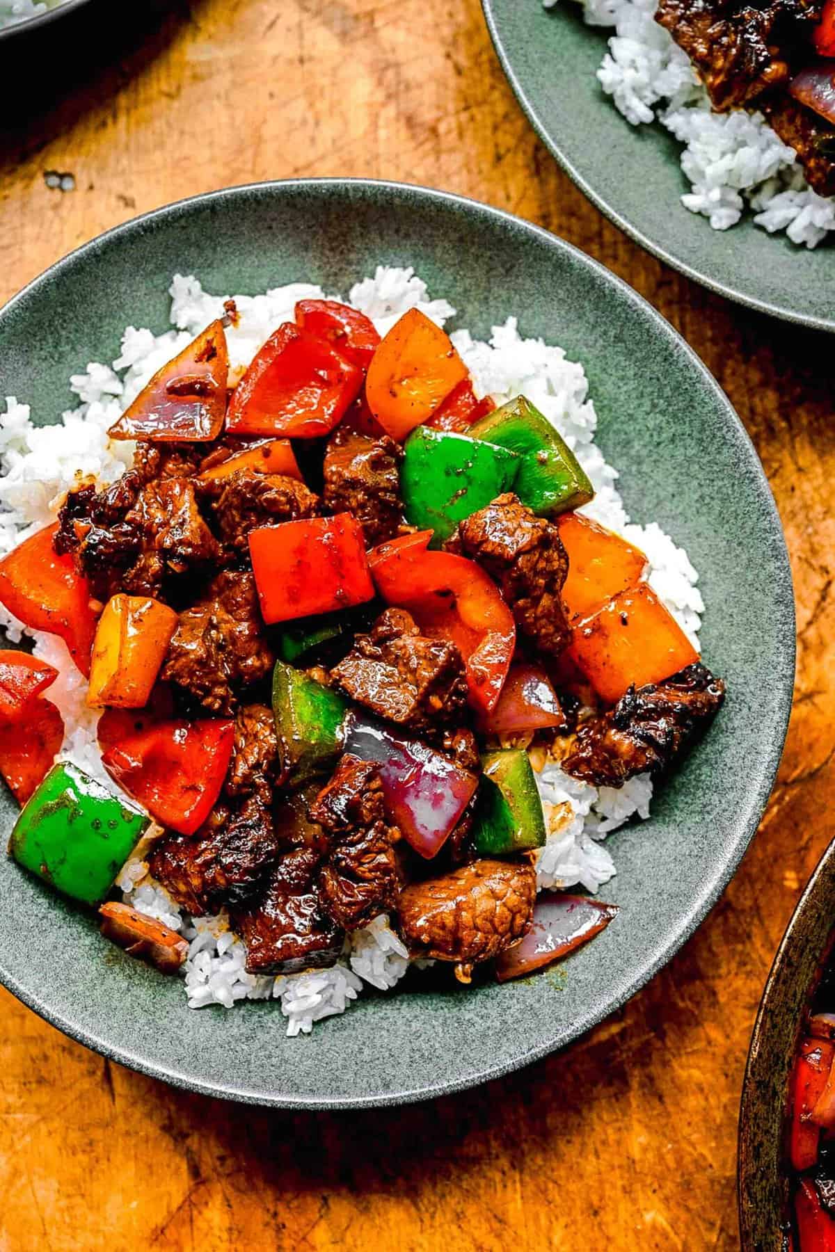 Bo luc lac served over rice in bowls.