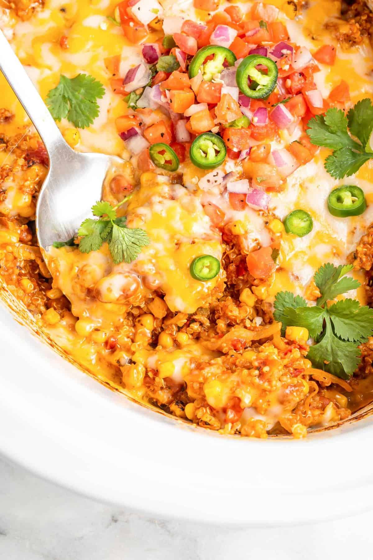 https://www.tablefortwoblog.com/wp-content/uploads/2023/02/slow-cooker-quinoa-enchilada-casserole-recipe-photo-tablefortwoblog-7-scaled.jpg