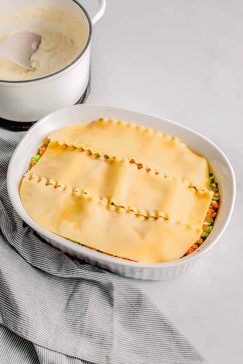 lasagna noodles are placed in an even layer.