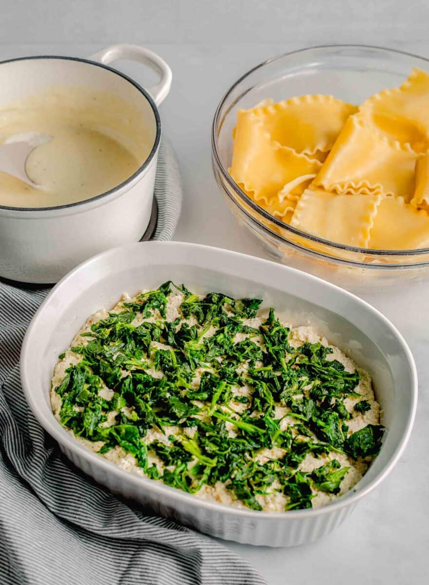 spinach is presented in a single layer in a casserole dish.