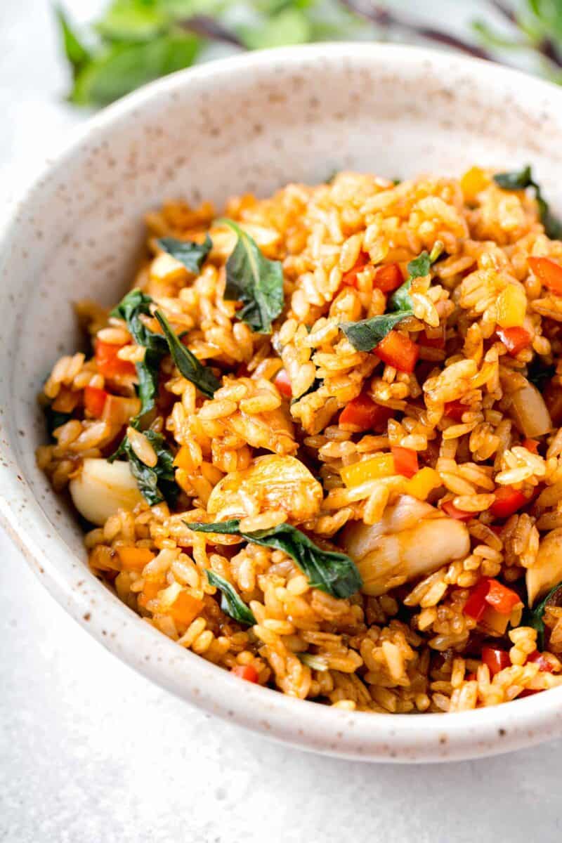 thai basil fried rice in a speckled bowl