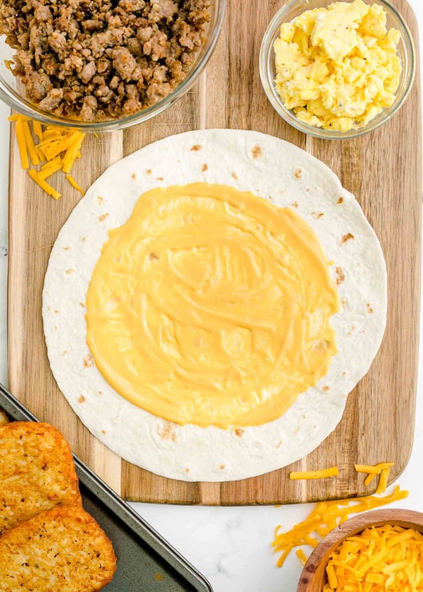 cheese is spread in a circle in the middle of a tortilla.