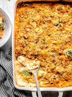 Chicken broccoli rice casserole in a casserole dish with a serving spoon.