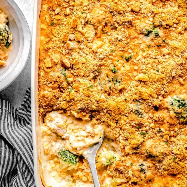 Chicken broccoli rice casserole in a casserole dish with a serving spoon.