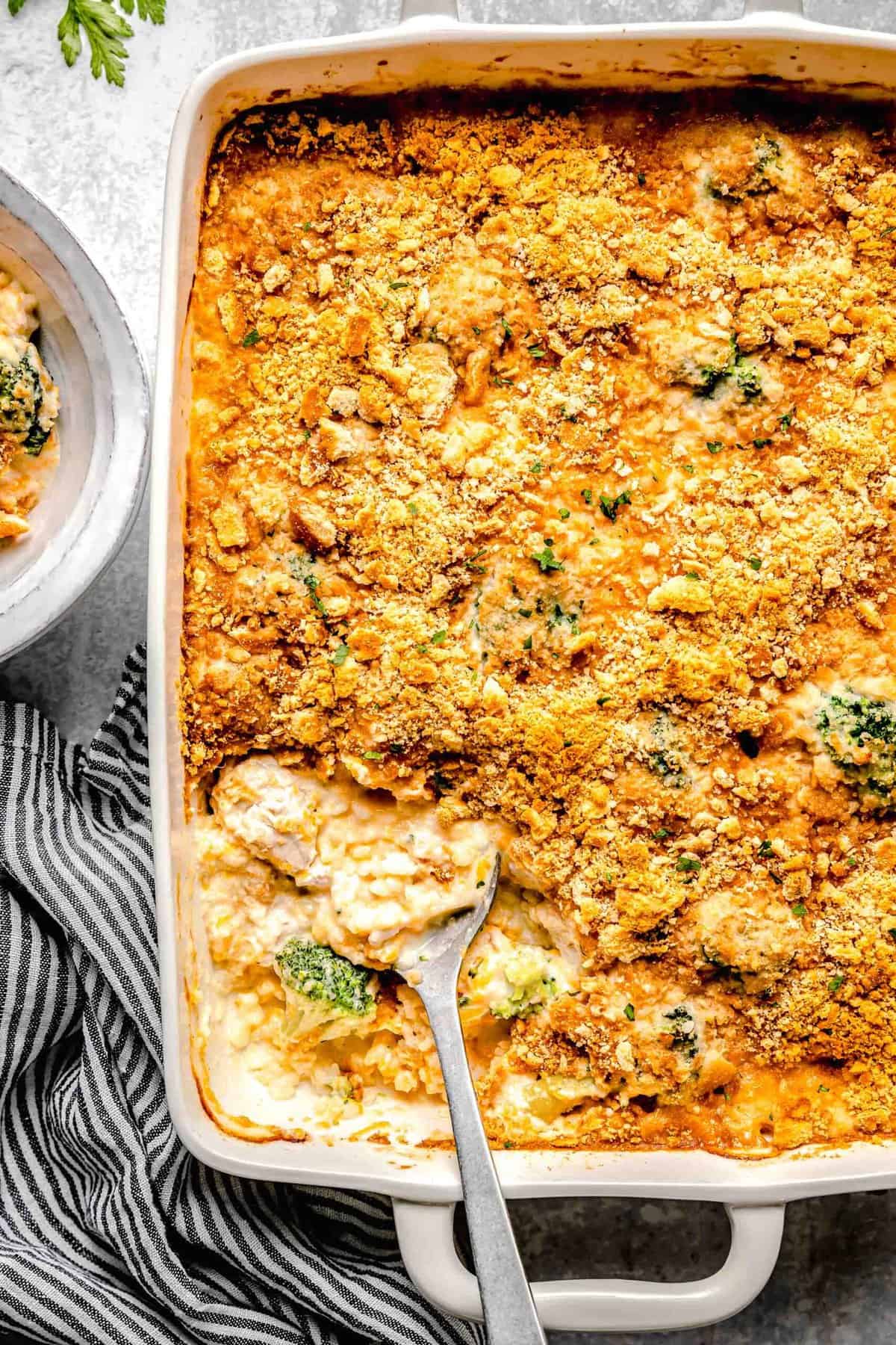 Chicken broccoli rice casserole in a casserole dish with a serving spoon.