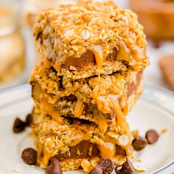 three carmelitas are stacked on a white plate.