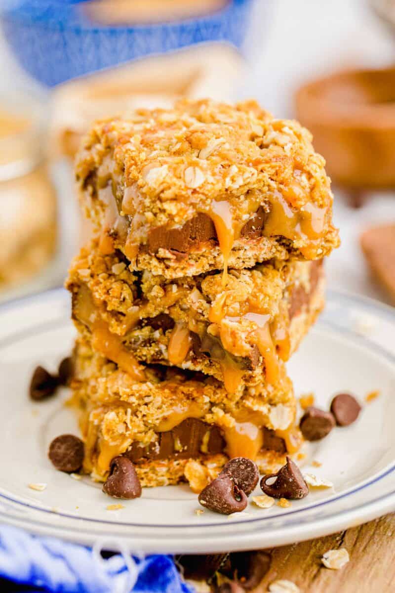 three carmelitas are stacked on a white plate.