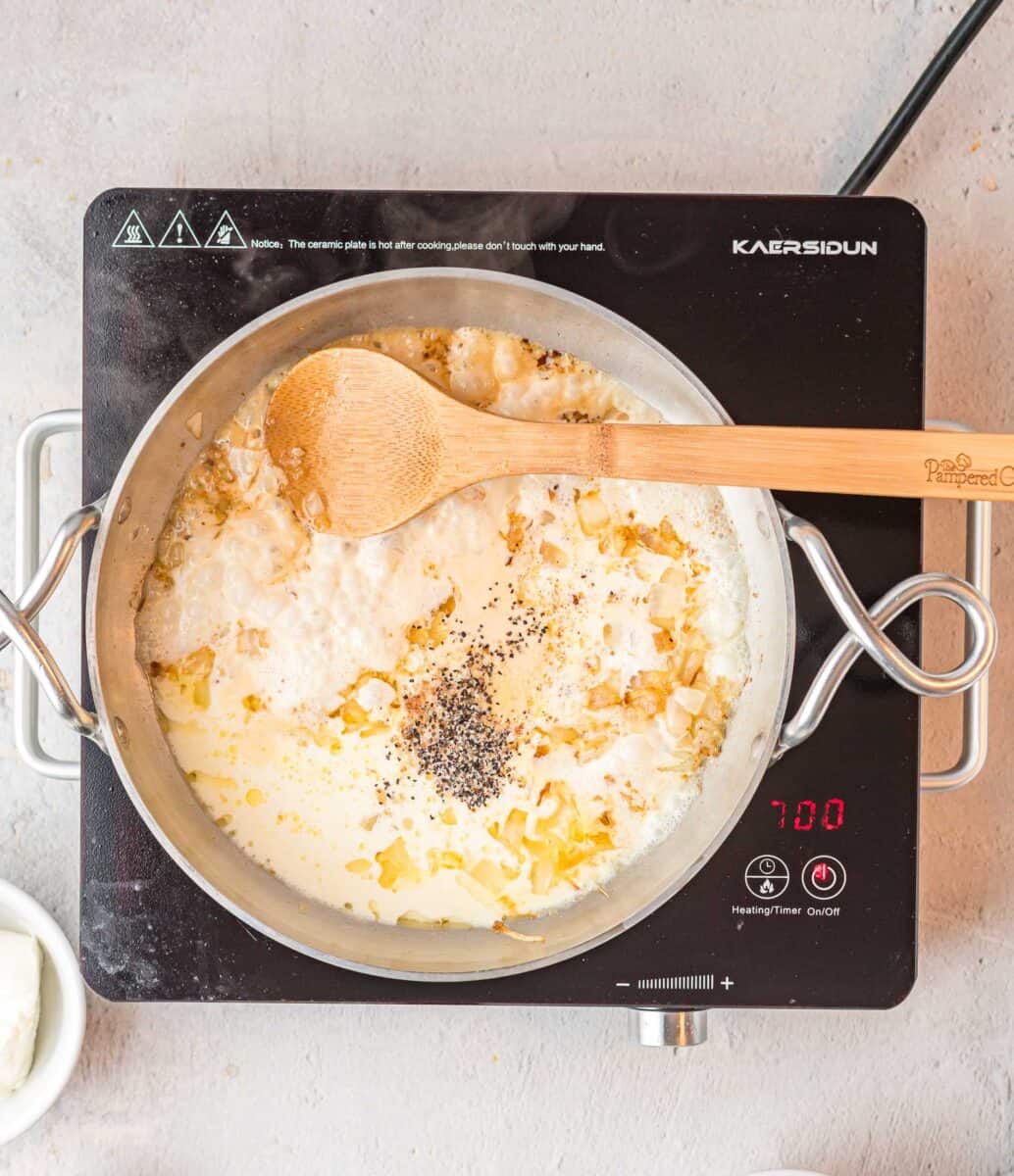 a wooden spoon is being used to mix ingredients in a skillet.