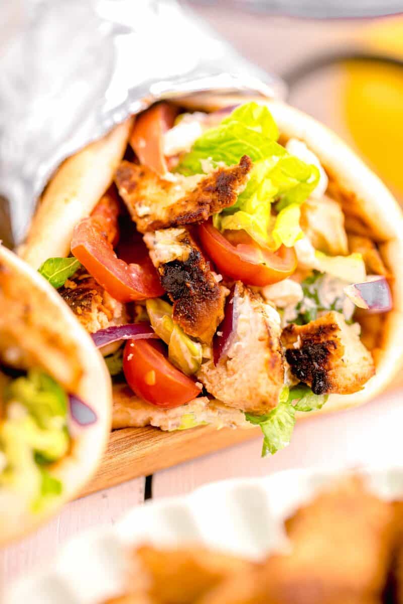 veggies and chicken fill a gyro.